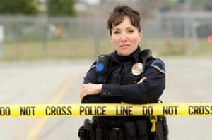 A police women standing with her arms crossed