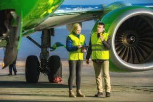 Airport workers completing a pre-flight checklist