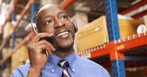 warehouse worker on cell phone PTT